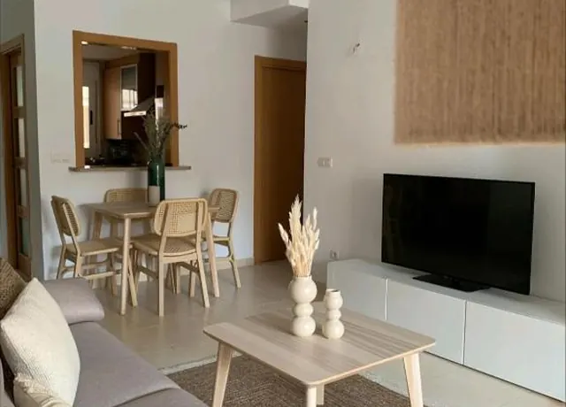 Living room with TV and dining area